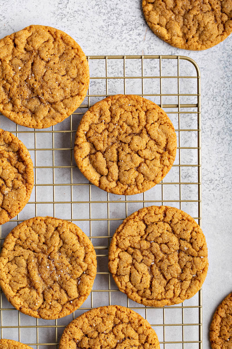 Molasses cookies on a cooling rack.