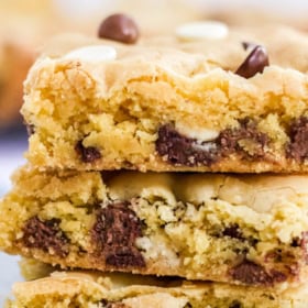 Up close image of chocolate chip cookie bars sliced and stacked on top of each other.