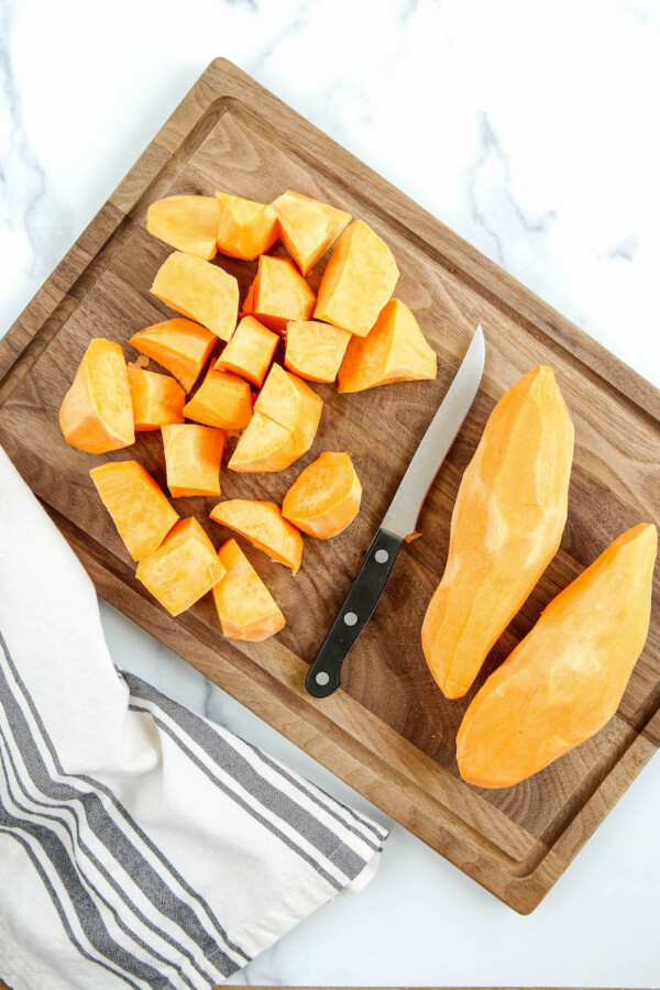 Chopped sweet potatoes with a knife.