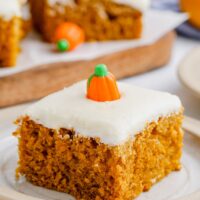 A pumpkin bar is on a plate with a candy pumpkin on top