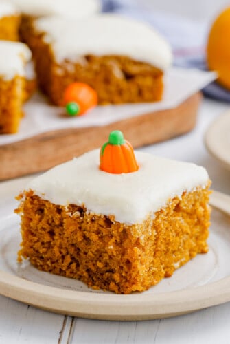 A pumpkin bar is on a plate with a candy pumpkin on top