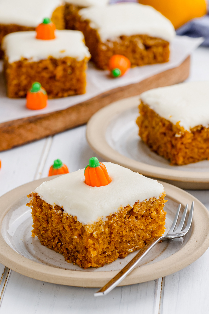 Slices of pumpkin bars are topped with candy orange pumpkins