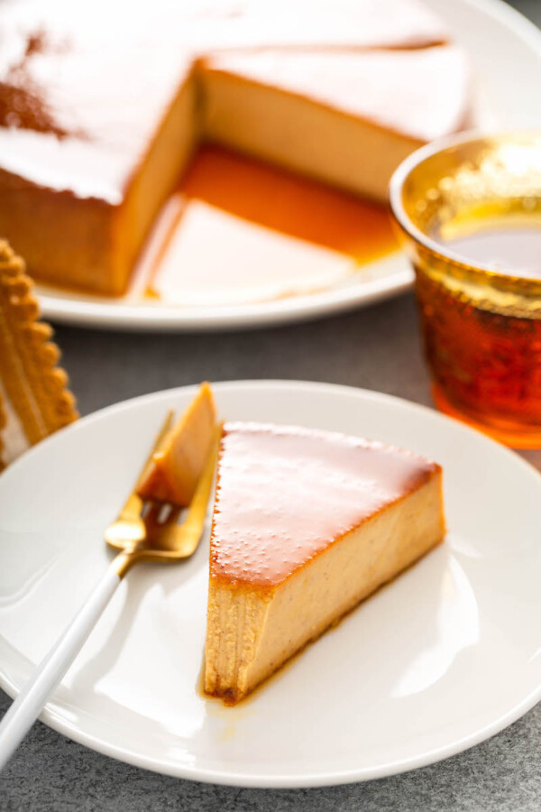 A forkful of pumpkin flan is removed from a slice