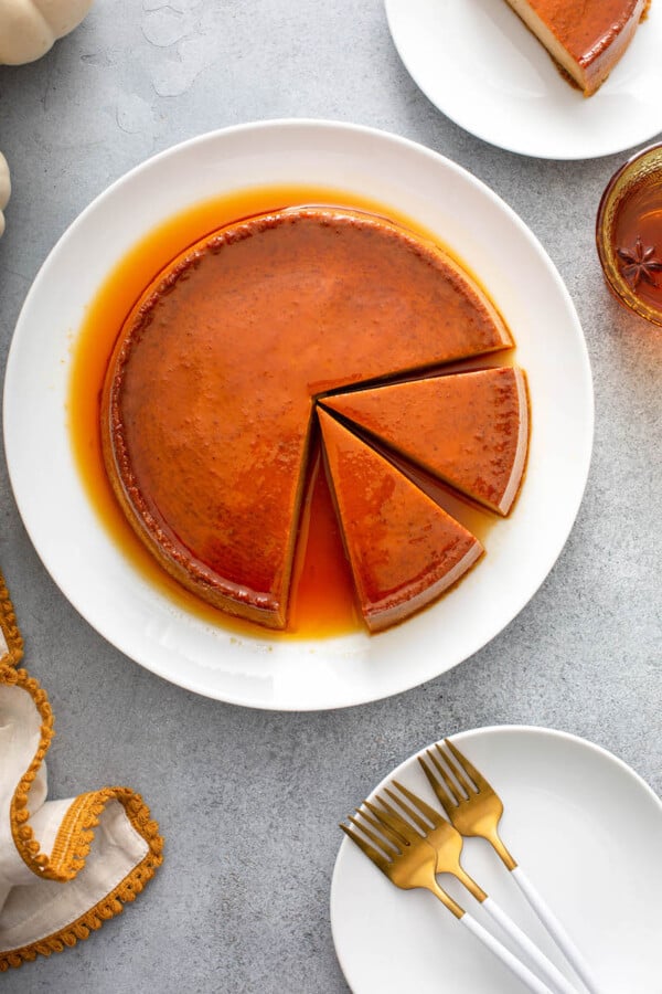 Two slices of pumpkin flan are cut out of the cake