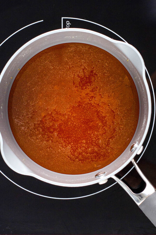 Melted, browned sugar is in a pot