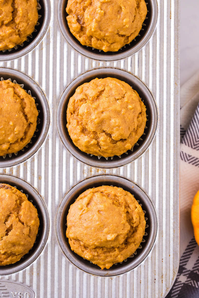 Baked pumpkin muffins in a pan.