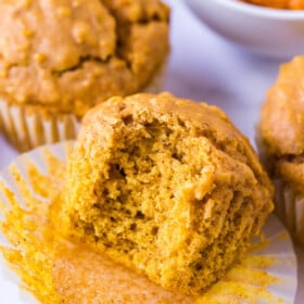 Oatmeal pumpkin muffin with a bite taken out of it.