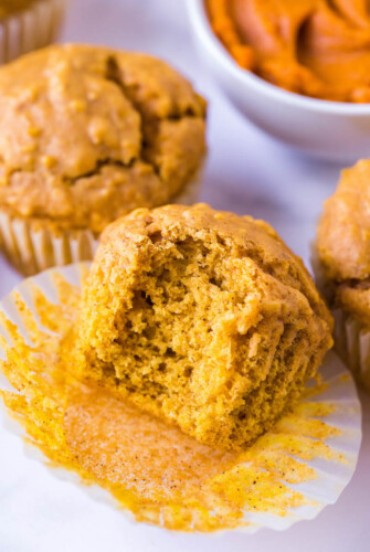 Oatmeal pumpkin muffin with a bite taken out of it.