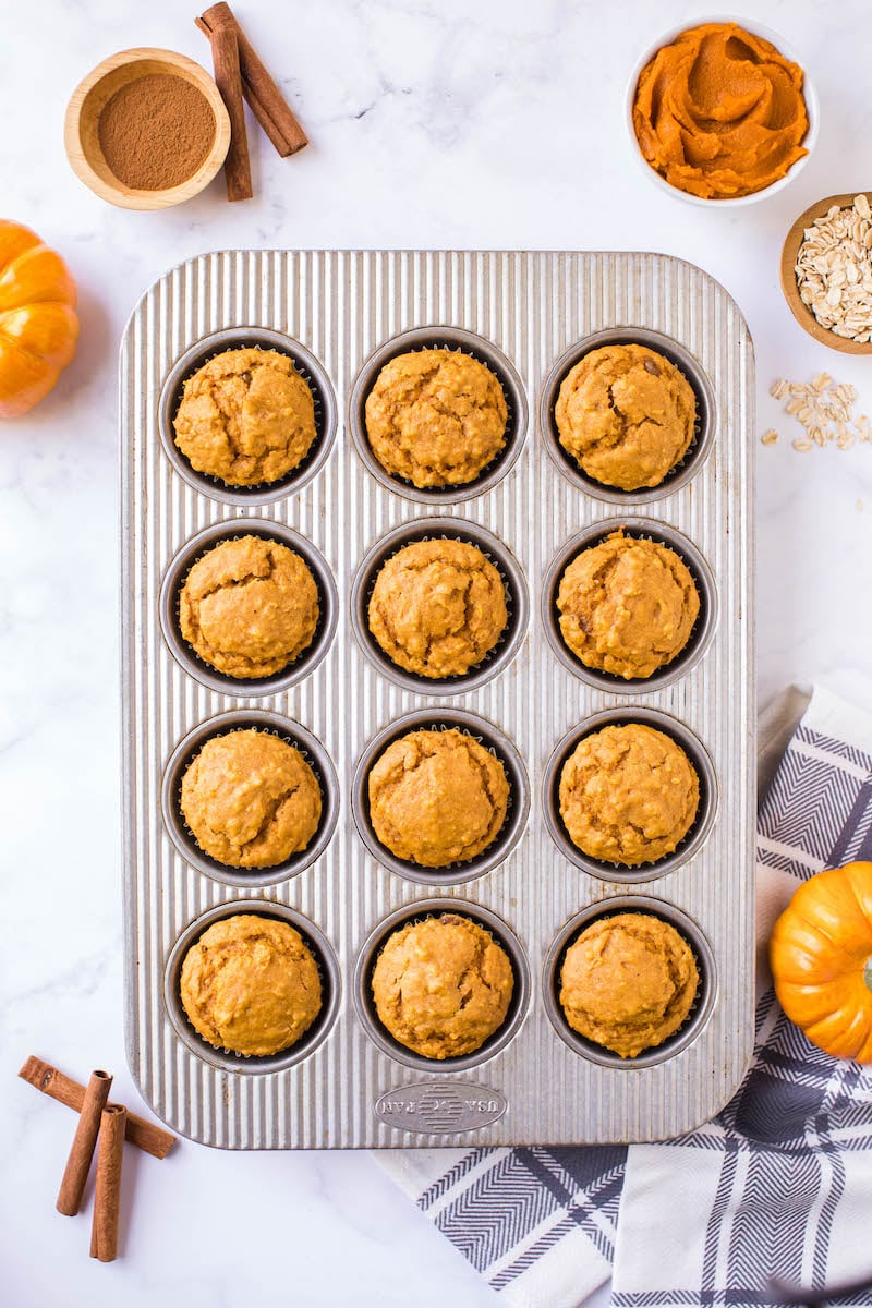 Baked pumpkin oatmeal muffins in a muffin pan.