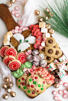 Board with festive Christmas cookies on it.