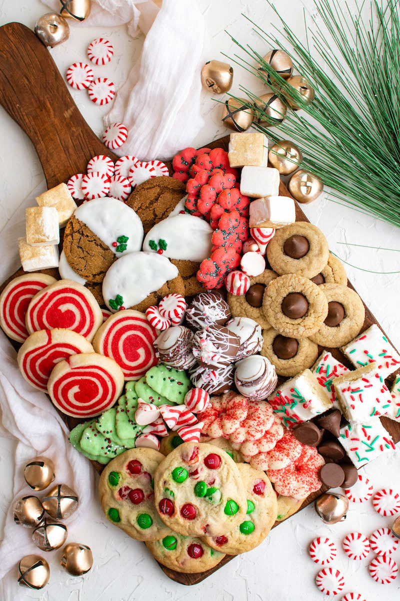 Board with festive Christmas cookies on it.