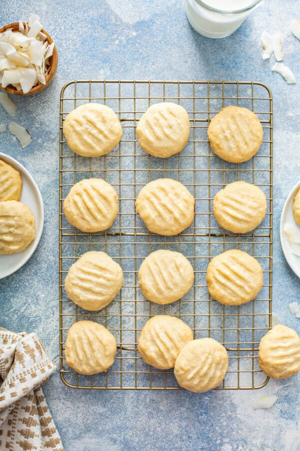 Coconut cookies are cooling on a wire cooling rack.