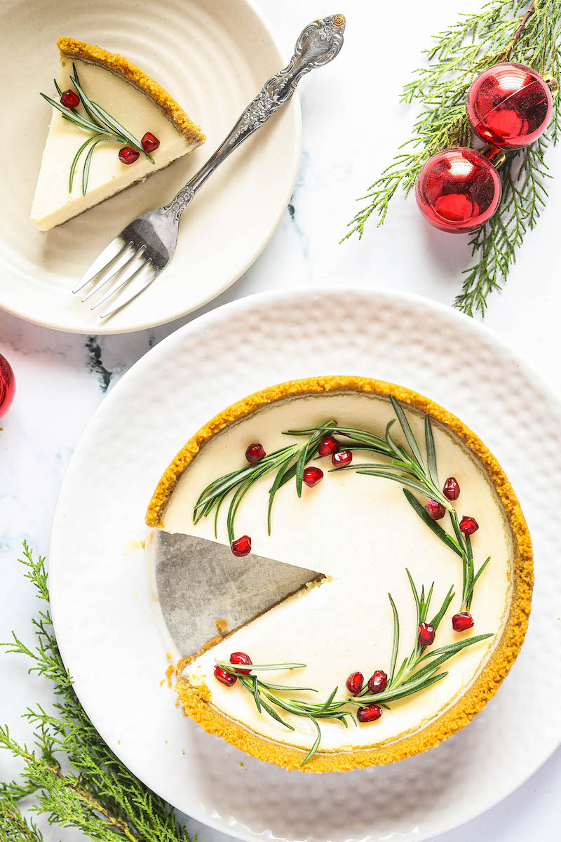 Christmas cheesecake with a slice take out of it.