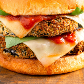 Up close image of eggplant Parmesan Sandwich with cheese and sauce.
