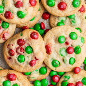 Overhead image of M&M cookies with red and green candies.
