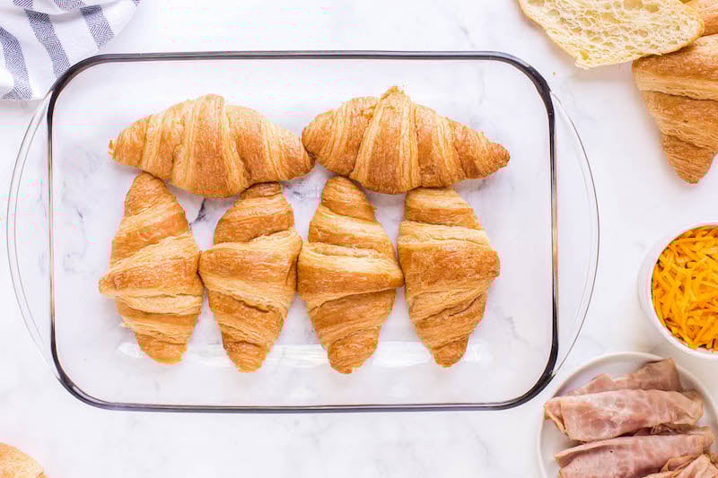6 croissants in a glass pan.