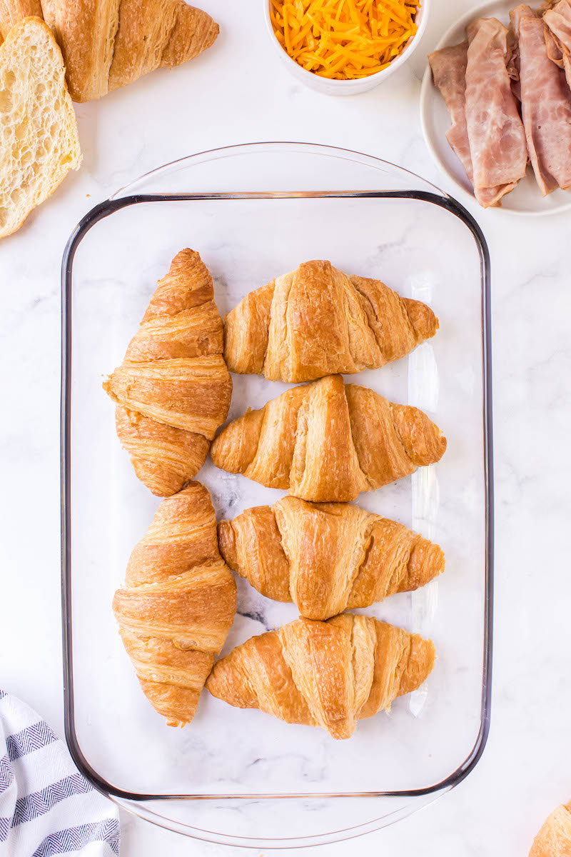 6 croissants in a glass pan.