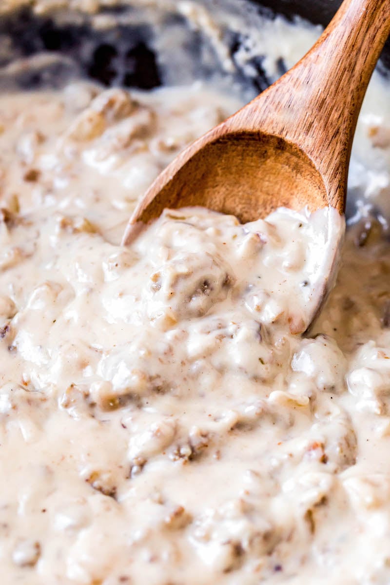 Sausage gravy on a wooden spoon.