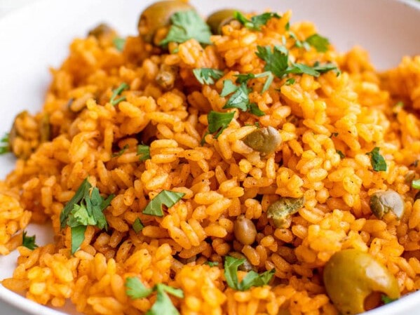Close-up of a serving of Arroz con Gandules topped with fresh cilantro