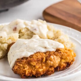 Plate of fried chicken with mashed potatoes.