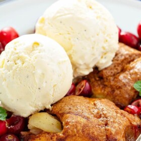 Cranberry Apple Dumplings in a bowl with vanilla ice cream