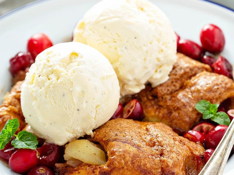 Cranberry Apple Dumplings in a bowl with vanilla ice cream