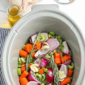 Chopped veggies in a crockpot.