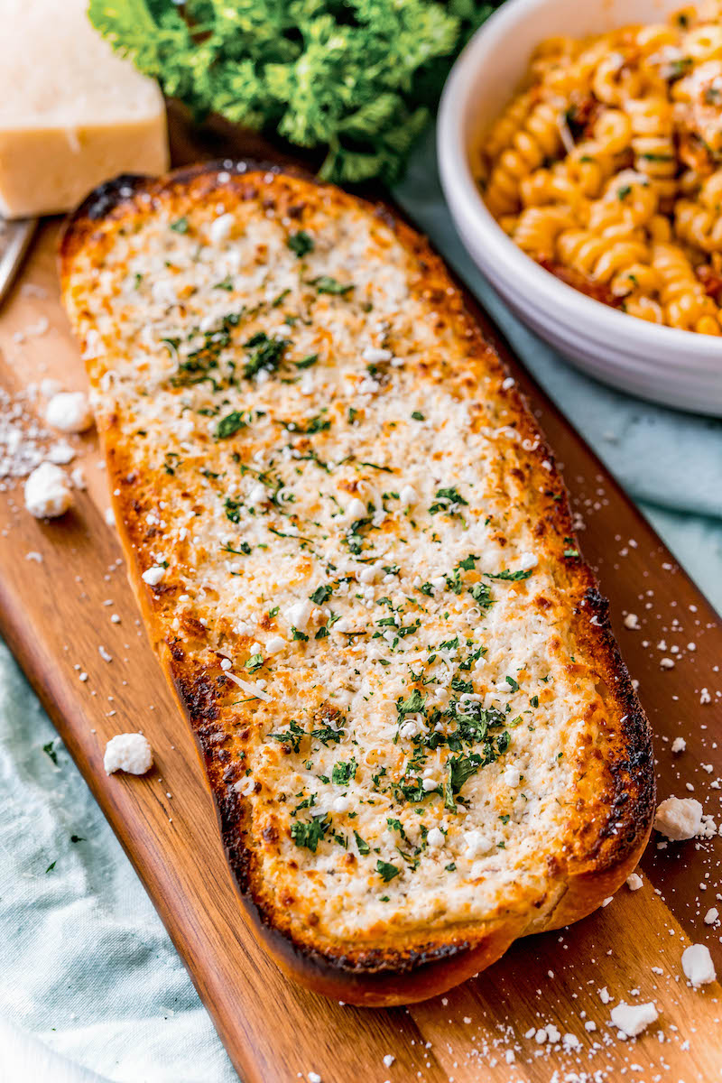 Garlic bread loaf on a cutting board.