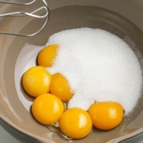 Egg yolks and sugar in a mixing bowl
