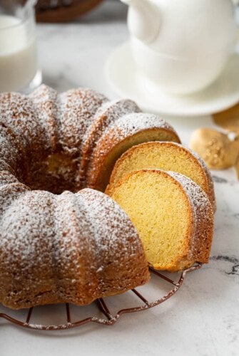 The orange rum bundt cake is sliced into, revealing a perfectly baked center.