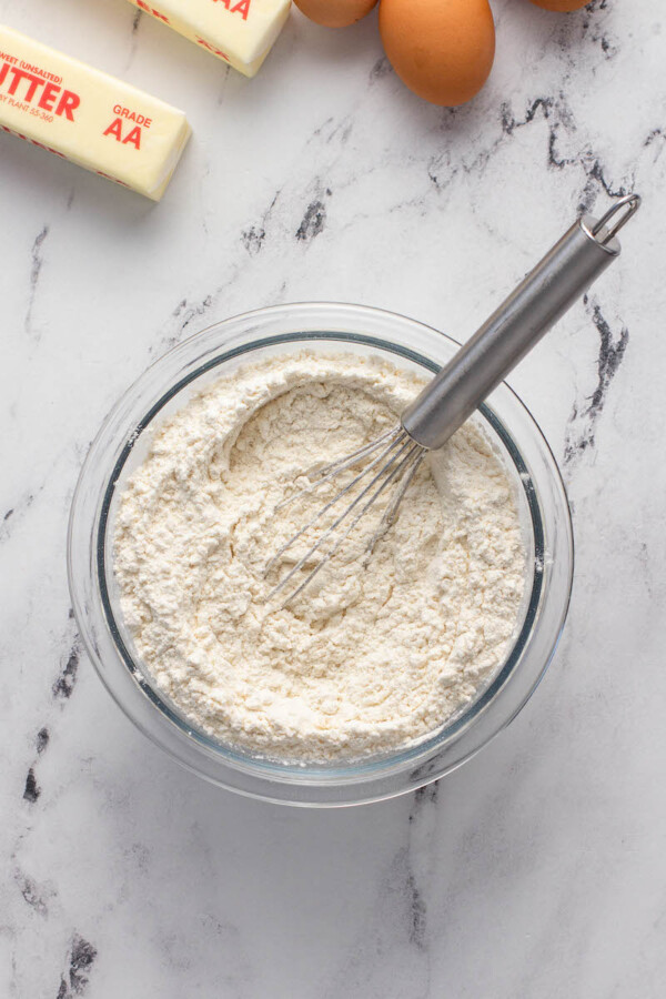 Cake mix is whisked in a glass bowl.