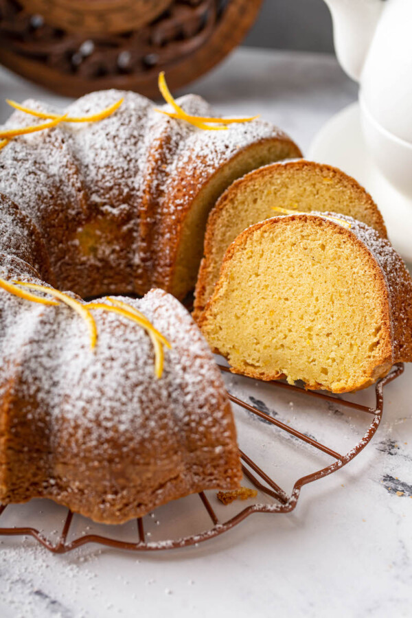 Orange zest and powdered sugar garnish a bundt cake.