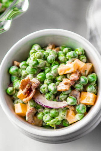 Bowl of loaded pea salad with bacon.