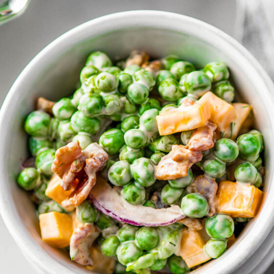 Bowl of loaded pea salad with bacon.