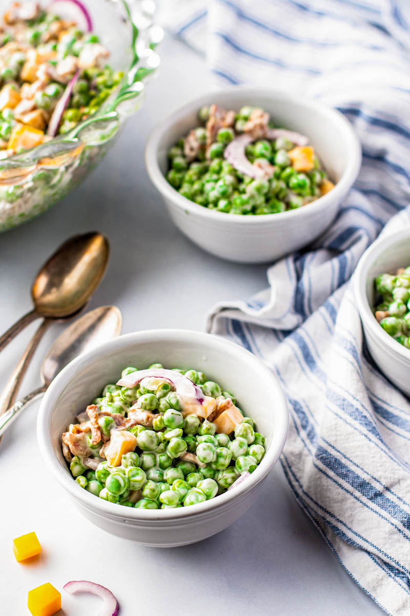 Two bowls of pea salad.