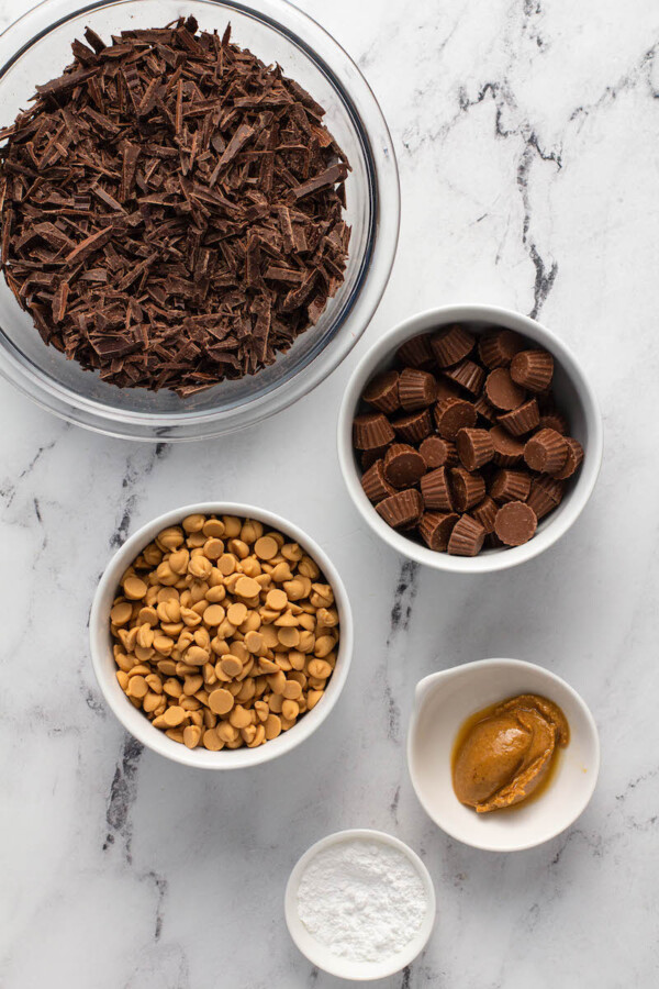 The ingredients for bark are in separate bowls on a marble surface.