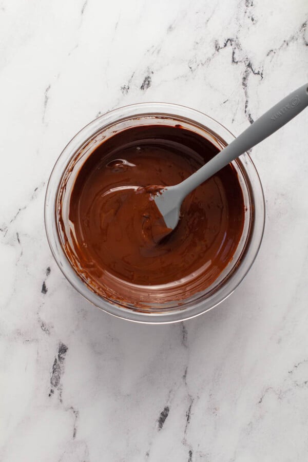 Chocolate is melted in a glass bowl.