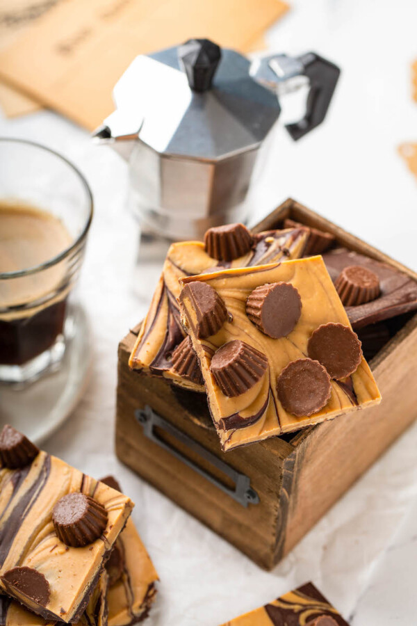 A close up shot shows mini peanut butter cups on a piece of bark.