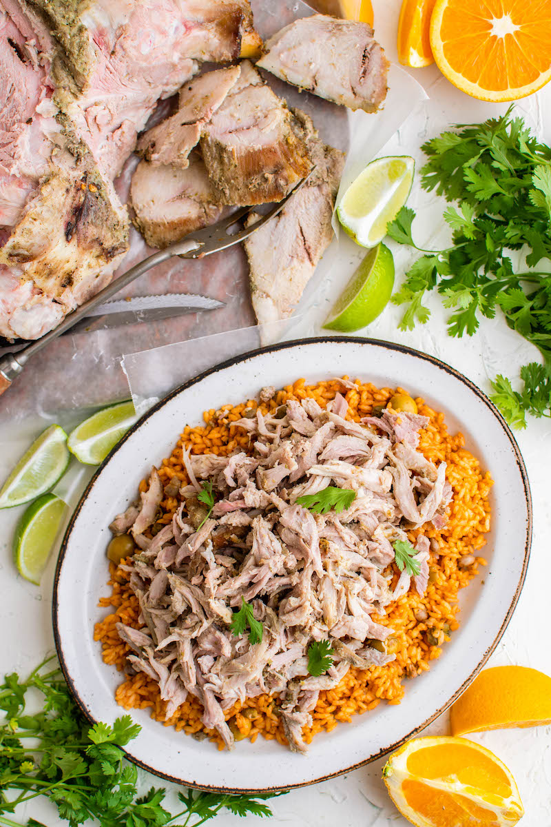 Puerto Rican Pernil is served on top of arroz con gandules. 