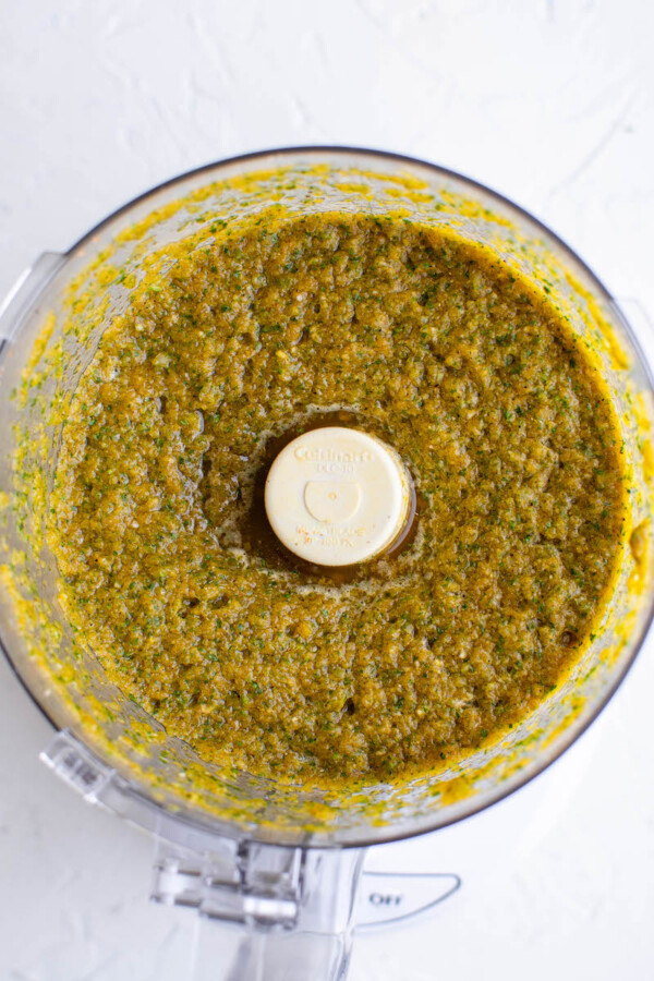 The ingredients and spices have been fully blended together, creating a greenish mixture.