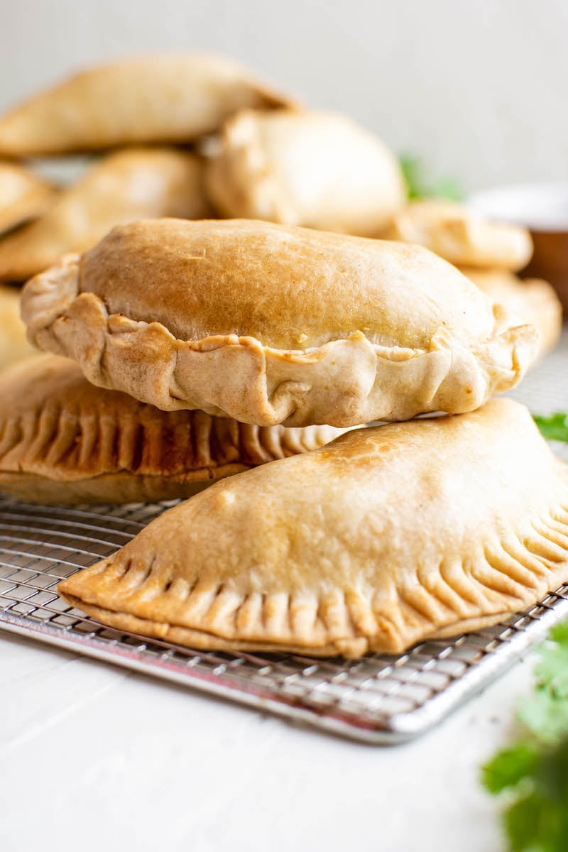Chicken empanadas stacked on top of each other.