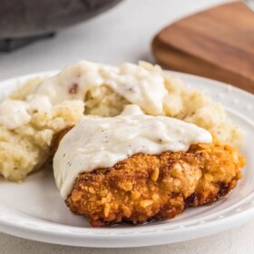 Chicken Fried Chicken with mashed potatoes and gravy on a plate