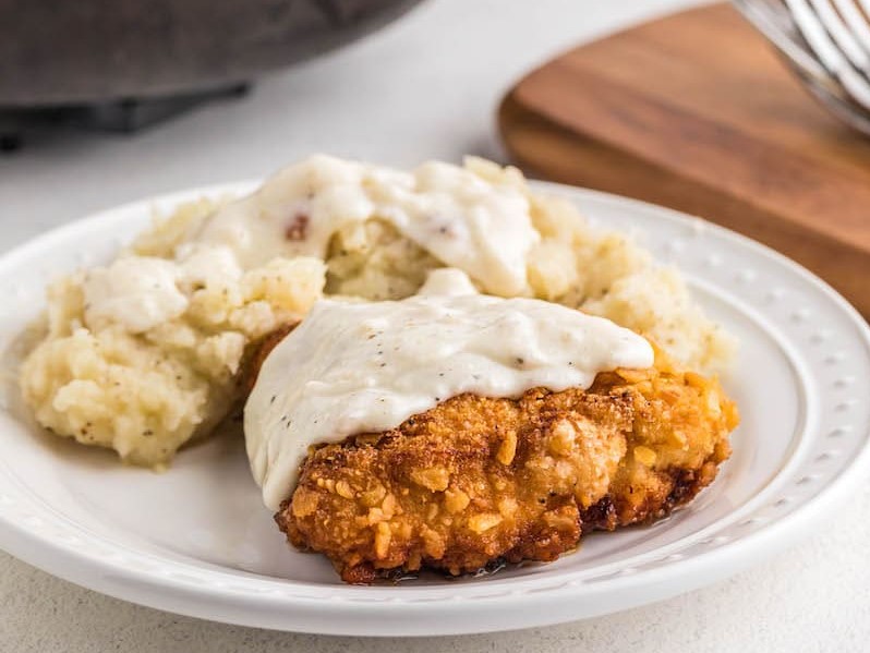 Chicken Fried Chicken with mashed potatoes and gravy on a plate