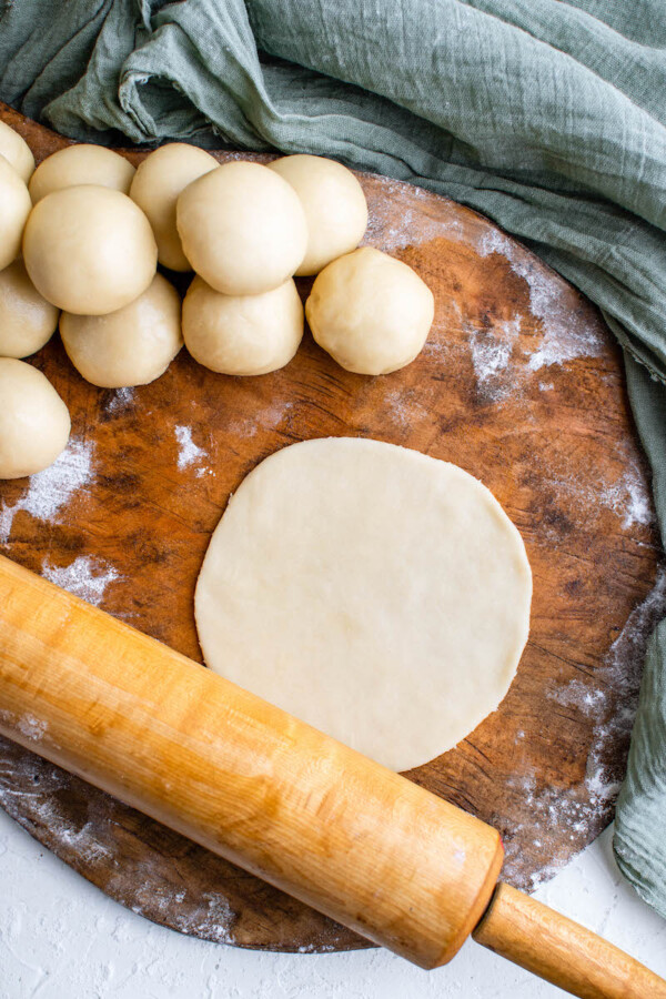 Disk of dough with a rolling pin.