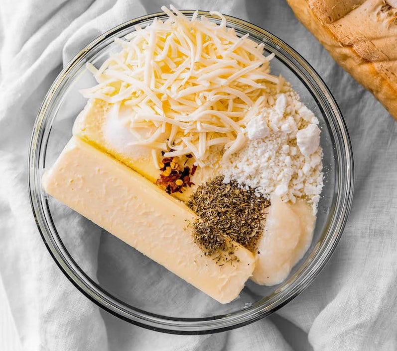 Bowl with butter, cheeses and seasoning.