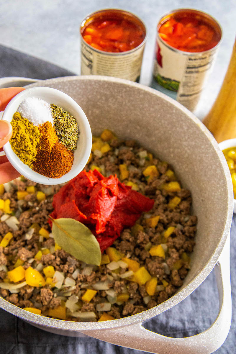 Spices being added to the chili.