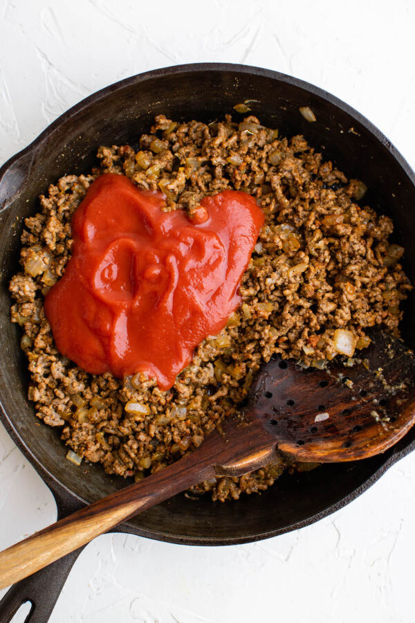 Ground beef and tomato sauce in a pan.