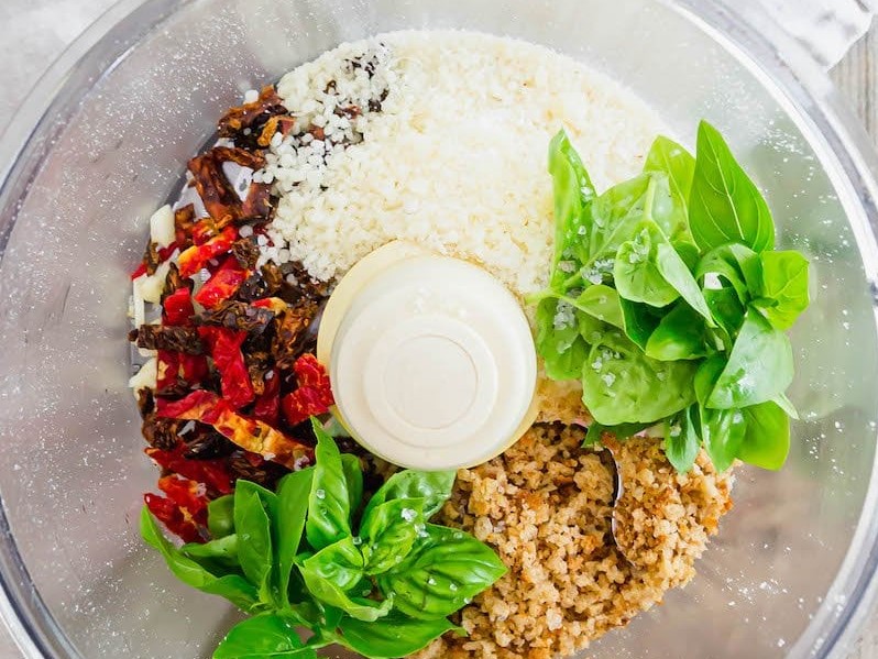 Ingredients for Sun-Dried Tomato Parmesan coating in a food processor bowl