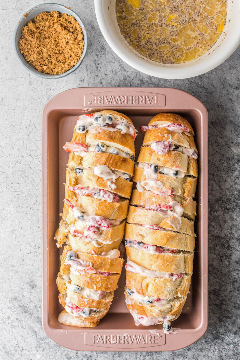 Sliced french bread stuffed with cream cheese and berries.