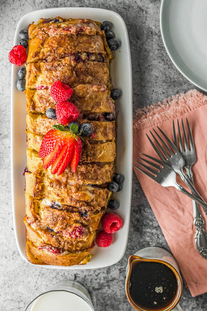 Loaf of sliced french toast with berries.